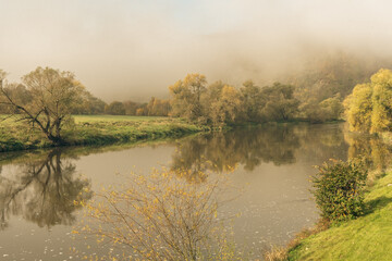 Forest lake in morning fog, autumn landscape