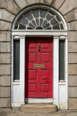 Red painted door in Ireland. Typical architecture