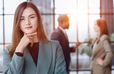 Portrait of a confident young businesswoman standing with her arms crossed in an office