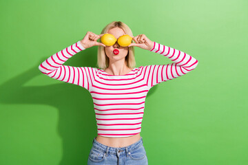 Photo of pretty young girl have fun hold two fresh fruits lemons blow air summer face skincare...