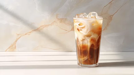 Zelfklevend Fotobehang Iced coffee in a glass with cream, ice cubes and grains on a light marble background with morning shadows. The concept of a cold summer drink. Copy space. © HN Works