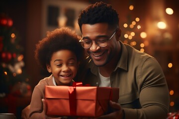 Fototapeta na wymiar Happy Fathers day. African american kid son giving gift box to dad for holiday at home, Concept of love in family