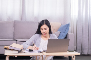 Asian stress headache female worried working at home calculate income and paying tax declarations using modern technology laptop, unsecured poor planning of single woman financial crisis or house loan