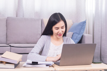 Asian happy female working at home calculate bookkeeping for tax declarations using modern technology laptop, well-organized planning financial payment for housing loan, women working paperwork bills