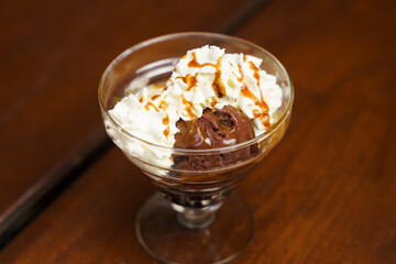 Chocolate and Vanilla Ice Cream with whipped cream on top with a bit of caramel