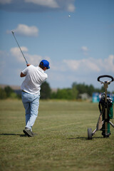Obraz premium Man Playing Golf on Beautiful Sunny Green Golf Course.
