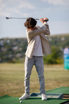 Golf Sport Concept : Ball and Golf club on artificial grass in golf driving range for training of golfer.