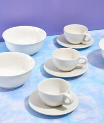 Beautiful table setting. Elegant dinnerware. White plates and cups.