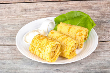 Stuffed pancakes with cream sauce