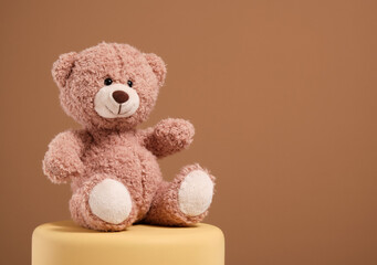 Soft teddy bear on the podium. Play time.