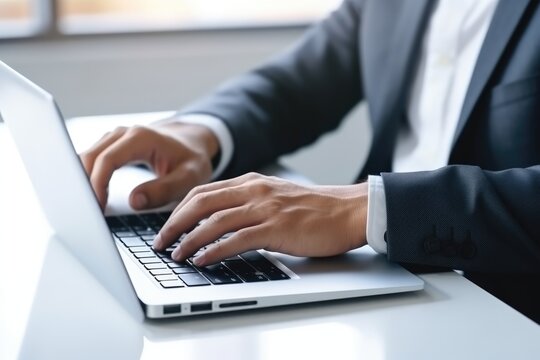 businessman hands typing on laptop