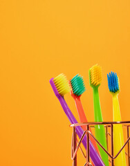 Green, red, purple, yellow toothbrushes on a colorful bright background. Copy space for text.