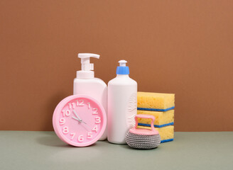 Washing dishes and pink clocks. Household and home hygiene routine.