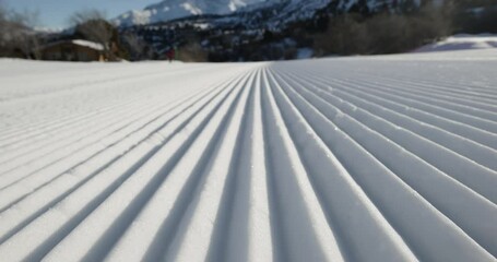 Perfectly prepared velvet snow of winter resort. Road, slope, ski run, velvet snow, track for skiers, snowboarders, professionals, amateur beginners. Safe, non-traumatic track for snowboarding skiing