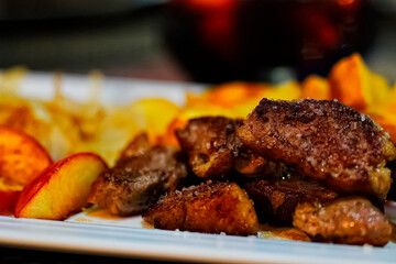 Restaurant, fried deer meat on a beautiful plate. Beautiful presentation. Unusual background.