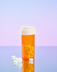 The jar is orange color with white pills. A few pills are scattered. Copy space. Treatment and prevention.