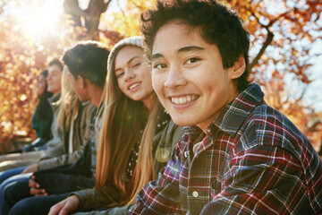 Teenager, group and portrait in park, boy and together on holiday, nature and relax by trees. Youth culture, happy friends and gen z school kids in sunshine, woods or garden for vacation in Canada