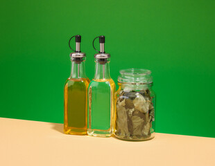 Glass dispensers with oils for salads and other foods. Bay leafs and delicious food.