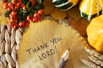 Thank You, LORD, handwritten quote on yellow leaf and wooden pencil with autumn still life. Top...