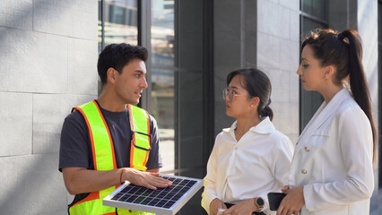 Electrical Engineer Technician explaining or offer solar cells renewable energy installation in...