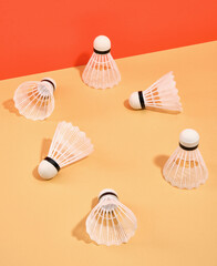 White badminton shuttlecocks scattered on the surface. Idea of sport.