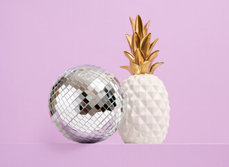 Disco ball and decorative deluxe pineapple. Concept of birthday party.