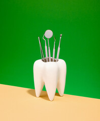 Dental instruments for treating dental disease stand in the white tooth. Oral dental hygiene.