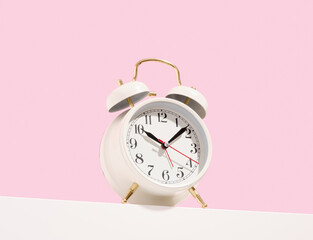 White vintage alarm clock. Work or study time. Deadline.