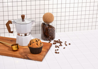 Coffee break with fresh beverage and muffin. Fresh organic coffee beans. Copy space for text.