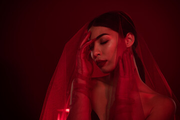 Photo of gorgeous asian lady femme fatale touch face passionate bride shoulders off isolated dark red color background