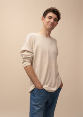 portrait of a young man in a light pullover posing for the camera, different emotions, on a light background