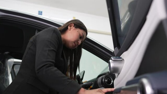 Female officer inspects electric car, electric car insurance concept