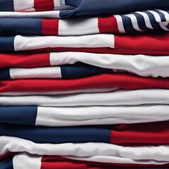 Red, blue and white T-shirts lie in a stack.