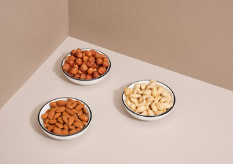 Three plates of various healthy nuts for health and beauty. Healthy product with vitamins.