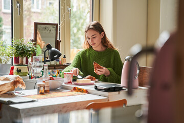 Waist up portrait of caucasian lovely woman preparing breakfast