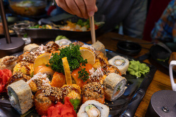a man holding a sushi with the chopstick