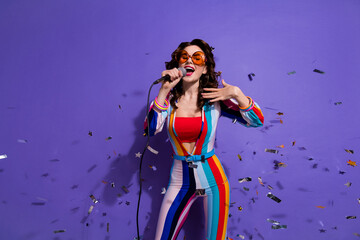 Photo of sweet cute girl dressed striped overall dark eyewear singing disco songs isolated violet...