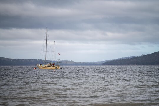 Boats in a harbour in Hobart Tasmania Australia, cray fishing boats and yachts, on blue clear water