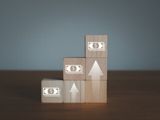 Rising currency in steps on wooden blocks