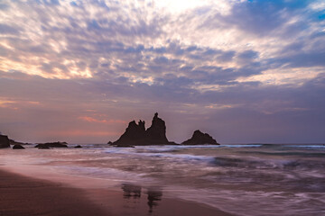 fiery summer sunset behind the typical rocks of benijio beach in the north east of tenerife island