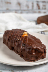 Chocolate and peanut cake. Peanut cake with fresh caramel filling on a plate. Close up
