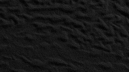 Volcanic black sand close up copy space top view background.