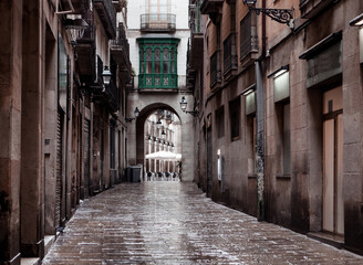 Fototapeta premium BARCELONA, CATALONIA - June 08: Old streets of Barrio Gotico in June 08, 2013 in Barcelona, Catalonia. It is centre of old city of Barcelona. Center of touristic life