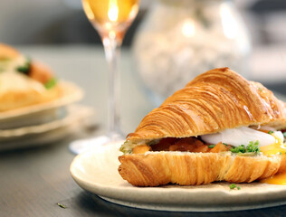 traditional croissant with salmon and egg for breakfast
