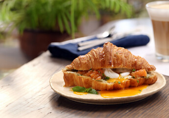 traditional croissant with salmon and egg for breakfast