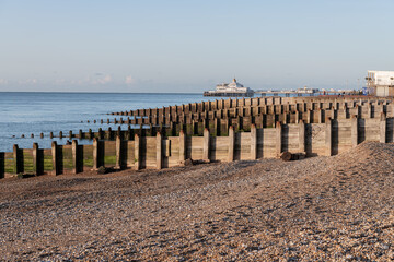 Eastbourne Pier and Beach with a clear blue sky and calm seas, Eastbourne, England