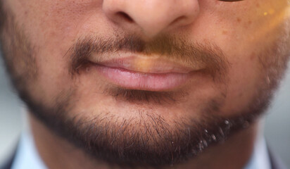 Obraz premium Close up cropped half face photo of stylish young man's bristle with thoughtful