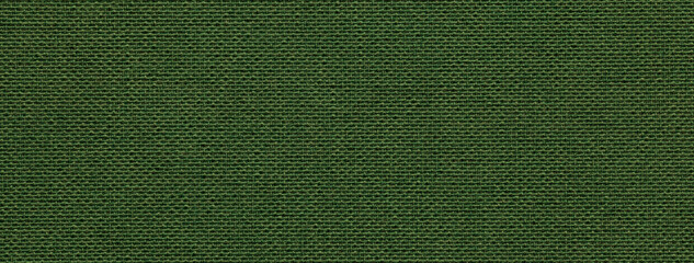 Texture of dark green color background from textile material with wicker pattern, macro. Vintage olive fabric