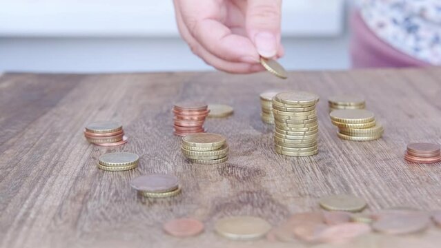 mother and child together putting euro coins into piles, counting, sorting out accumulated wealth, savings, concept financial literacy of children, Family Budget, Financial Responsibility, Management