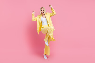 Full body photo of lovely delighted lady stand one leg raise fists accomplishment empty space isolated on pink color background